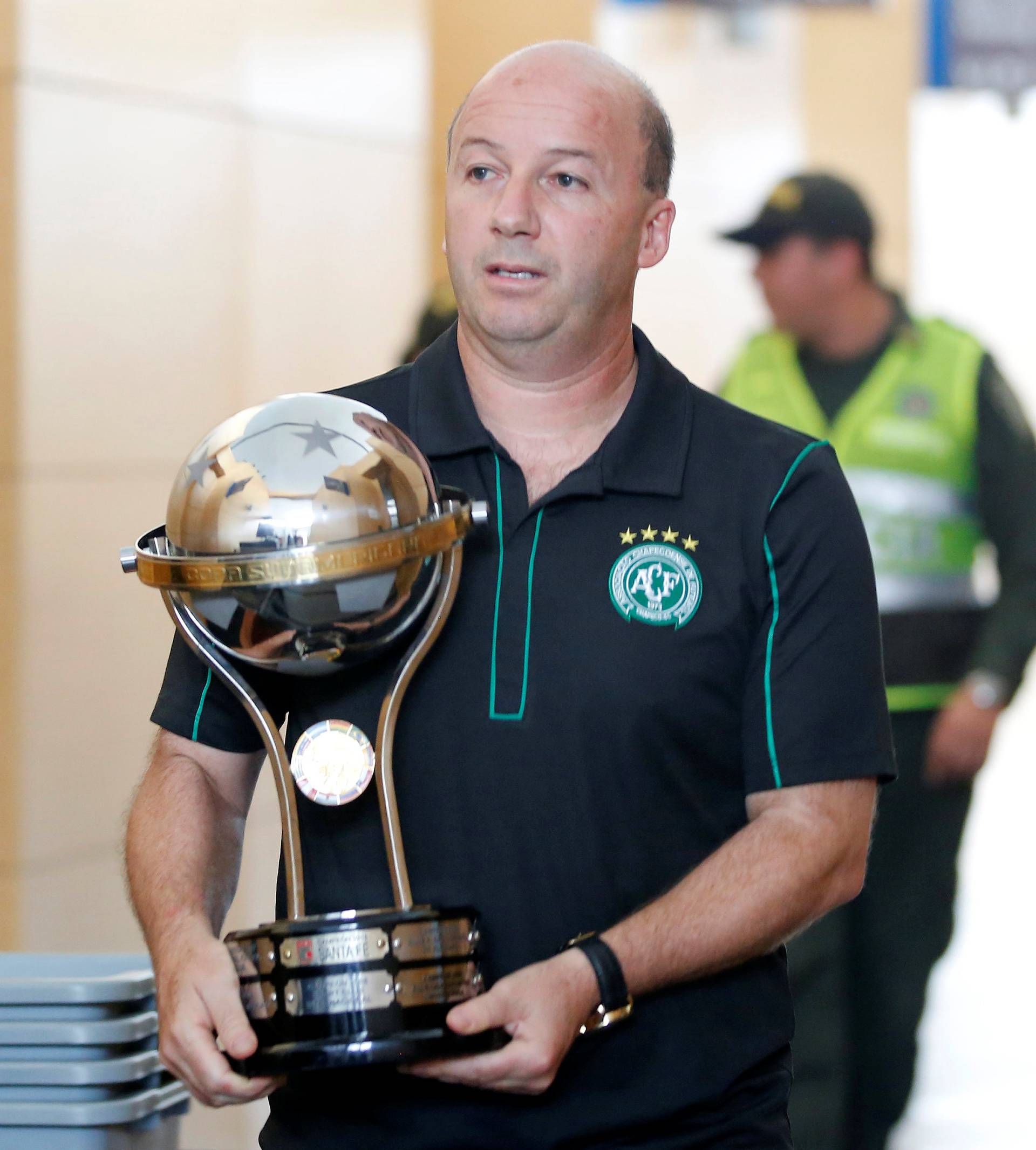 Marcelo Zolet, legal advisor to the Brazilian soccer team Chapecoense, carries a replica of the South American trophy after receiving from directors of Colombian club Santa Fe, the last Sudamericana Cup champion in Medellin