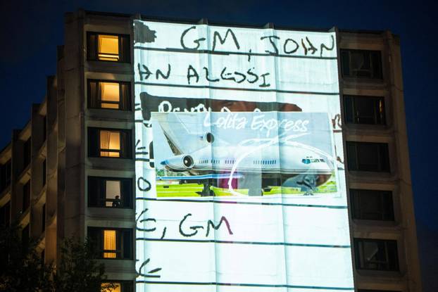 Documents and photos of Jeffrey Epstein and U.S. President Trump projected onto Hilton ahead of WHCA Gala, in Washington, D.C.
