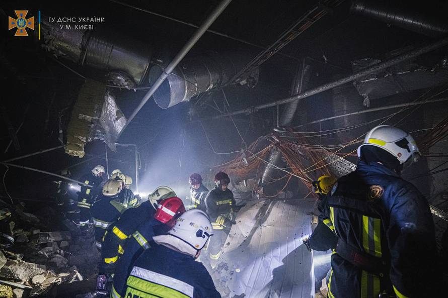 Rescuers work at the site of a shopping mall damaged by an airstrike in Kyiv