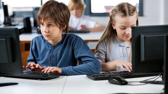 Cute,Little,Schoolchildren,Using,Desktop,Pc,At,Desk,In,Computer