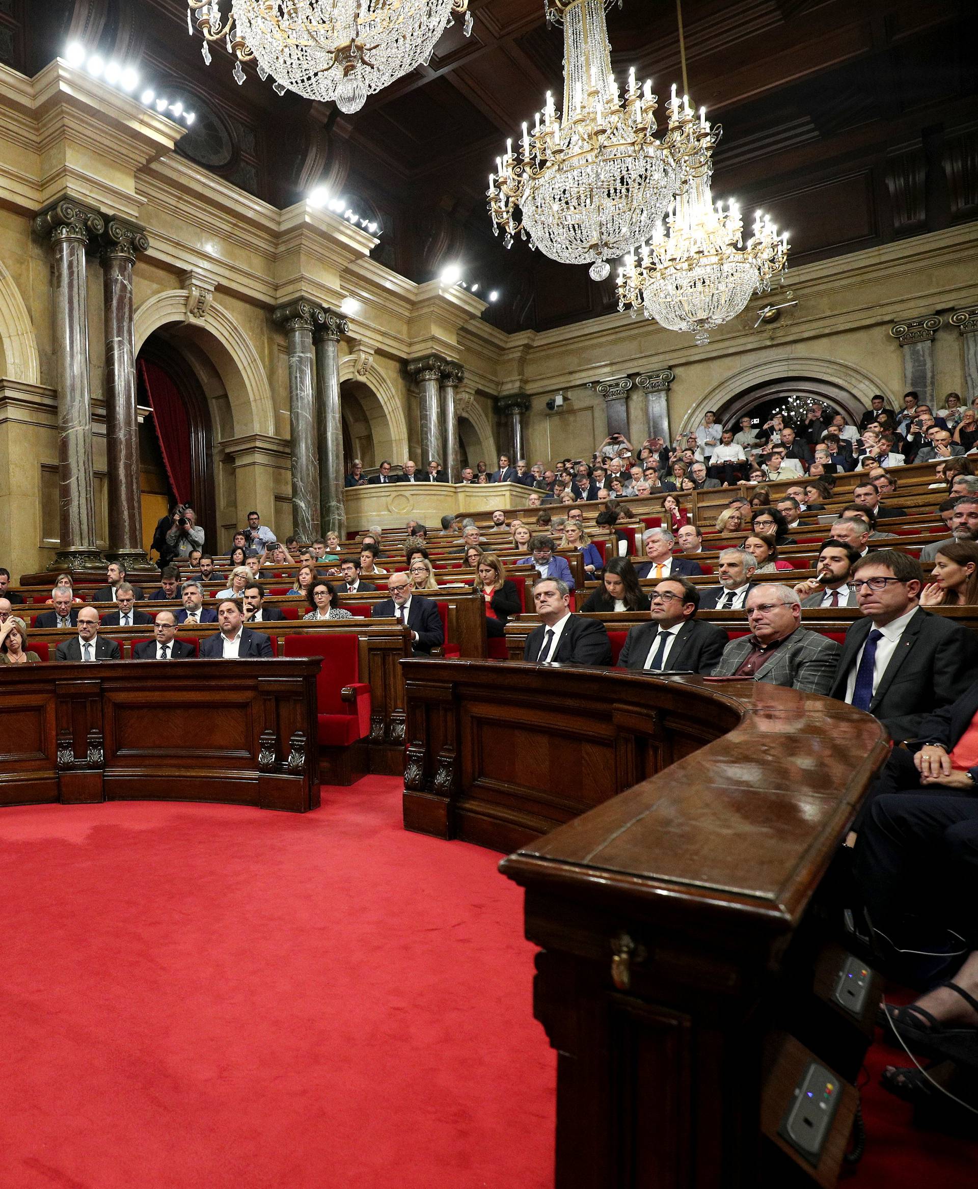 Catalan President Carles Puigdemont speaks in the chamber at the Catalonian regional parliament in Barcelona