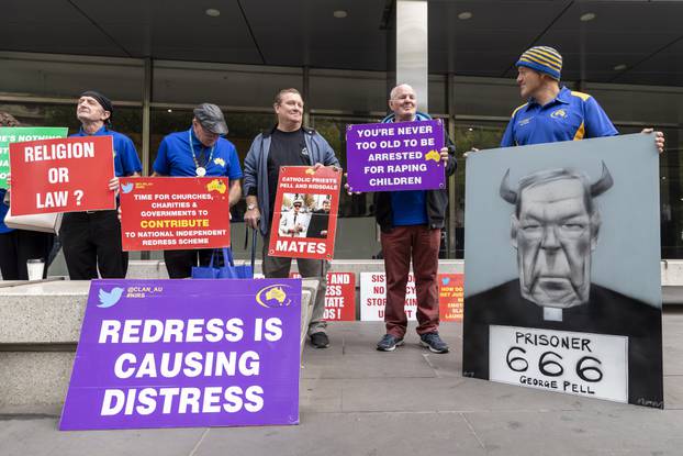 Protesters of Cardinal George Pell are seen outside the County Court in Melbourne