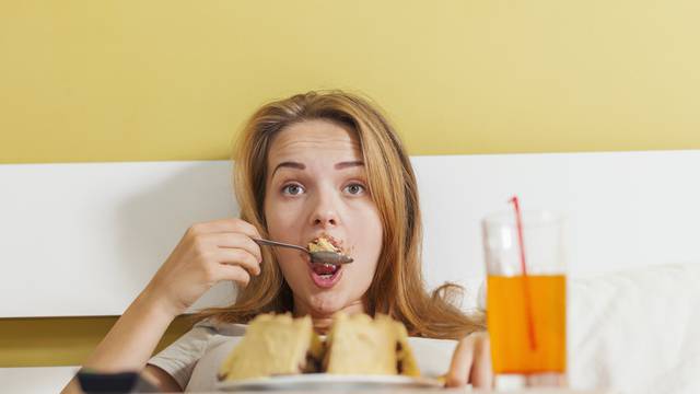 Day gluttony, teen girl eating a cake and drinks soda