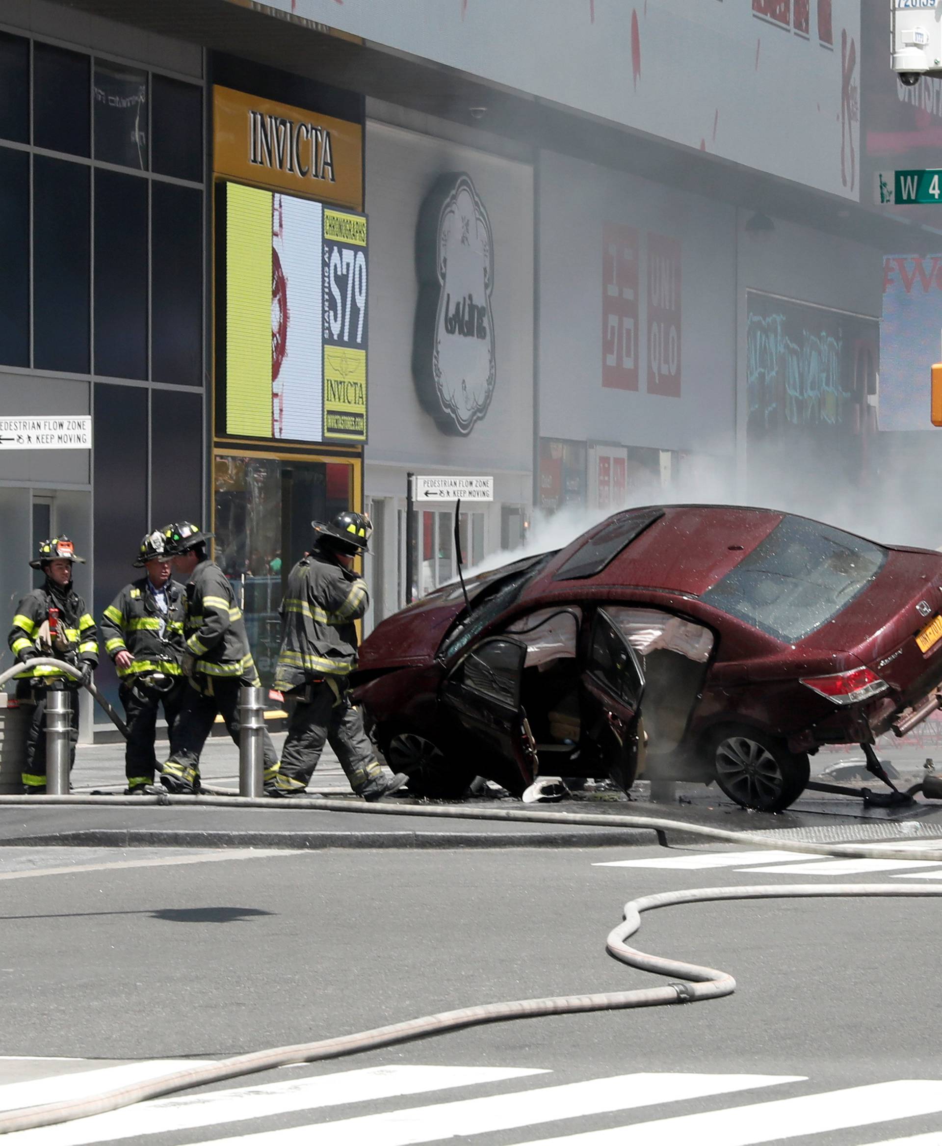 A vehicle that struck pedestrians in Times Square and later crashed is seen on the sidewalk in New York City