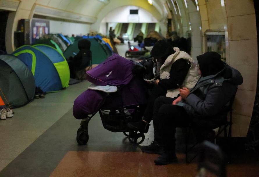 People take shelter inside a metro station during a Russian missile and drone attack in Kyiv