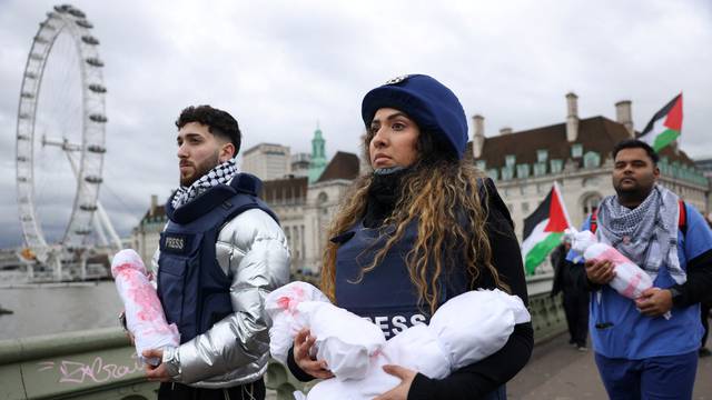 Health workers participate in a silent procession during a vigil for Gaza in London