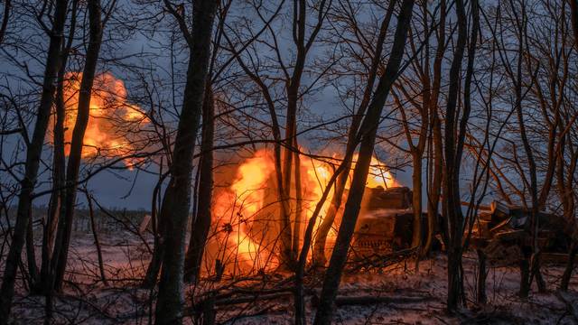 Ukrainian service members fire a self-propelled howitzer toward Russian troops near a front line in Kharkiv region
