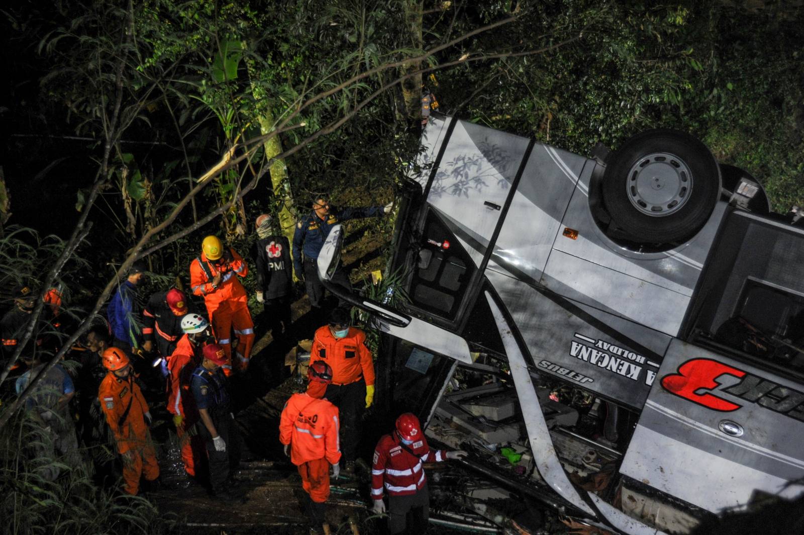 Rescue personnel work at the crash site after a bus fell into a ravine in Sumedang, Indonesia