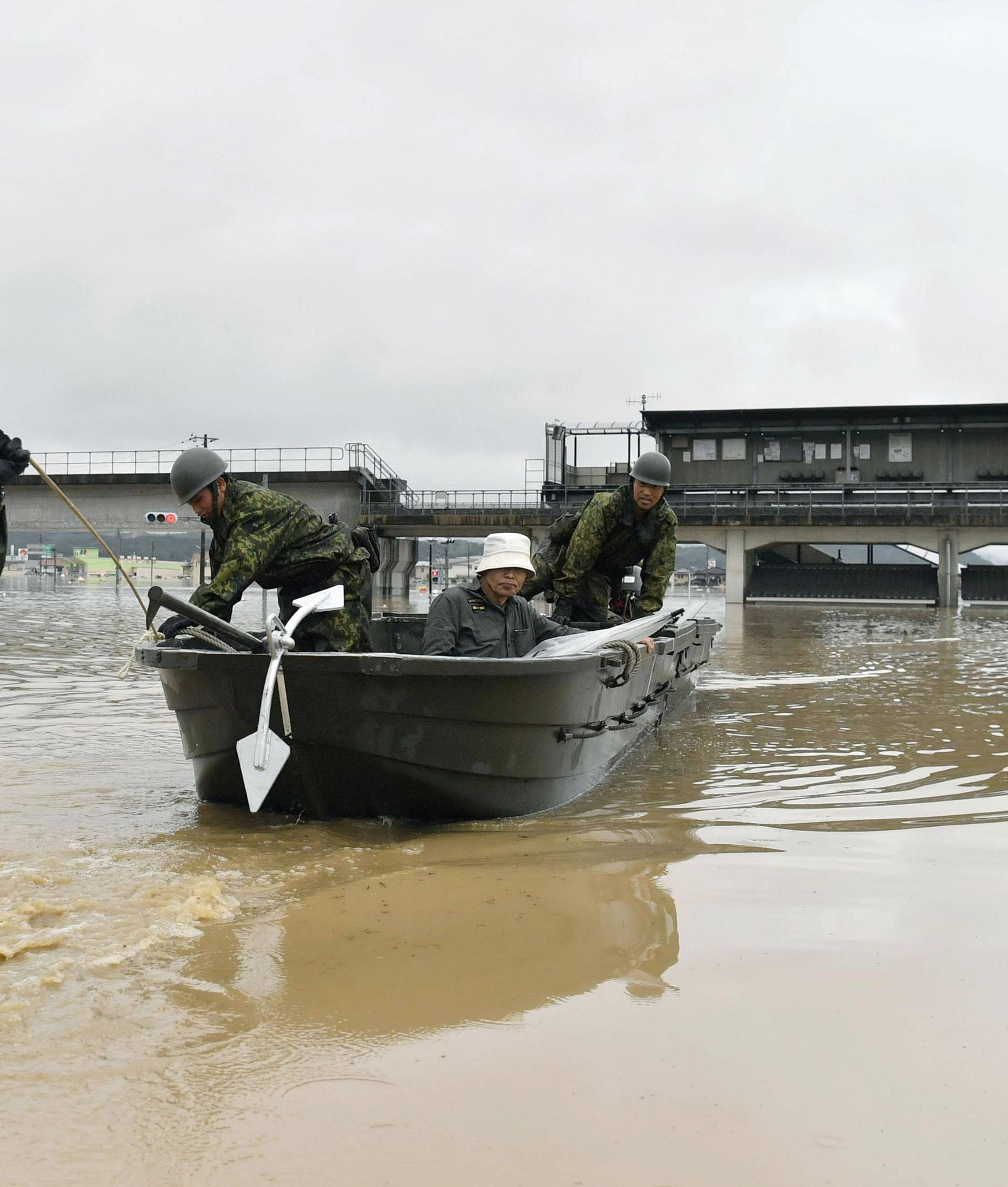 A local resident is rescued from a flooded area in Kurashiki