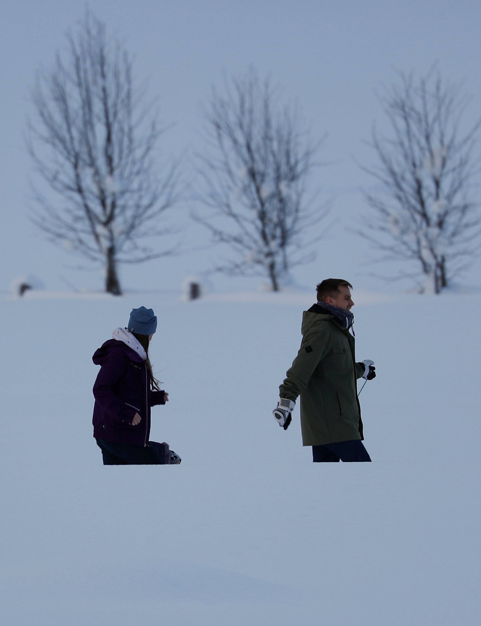 People walk after heavy snowfall in Flachau