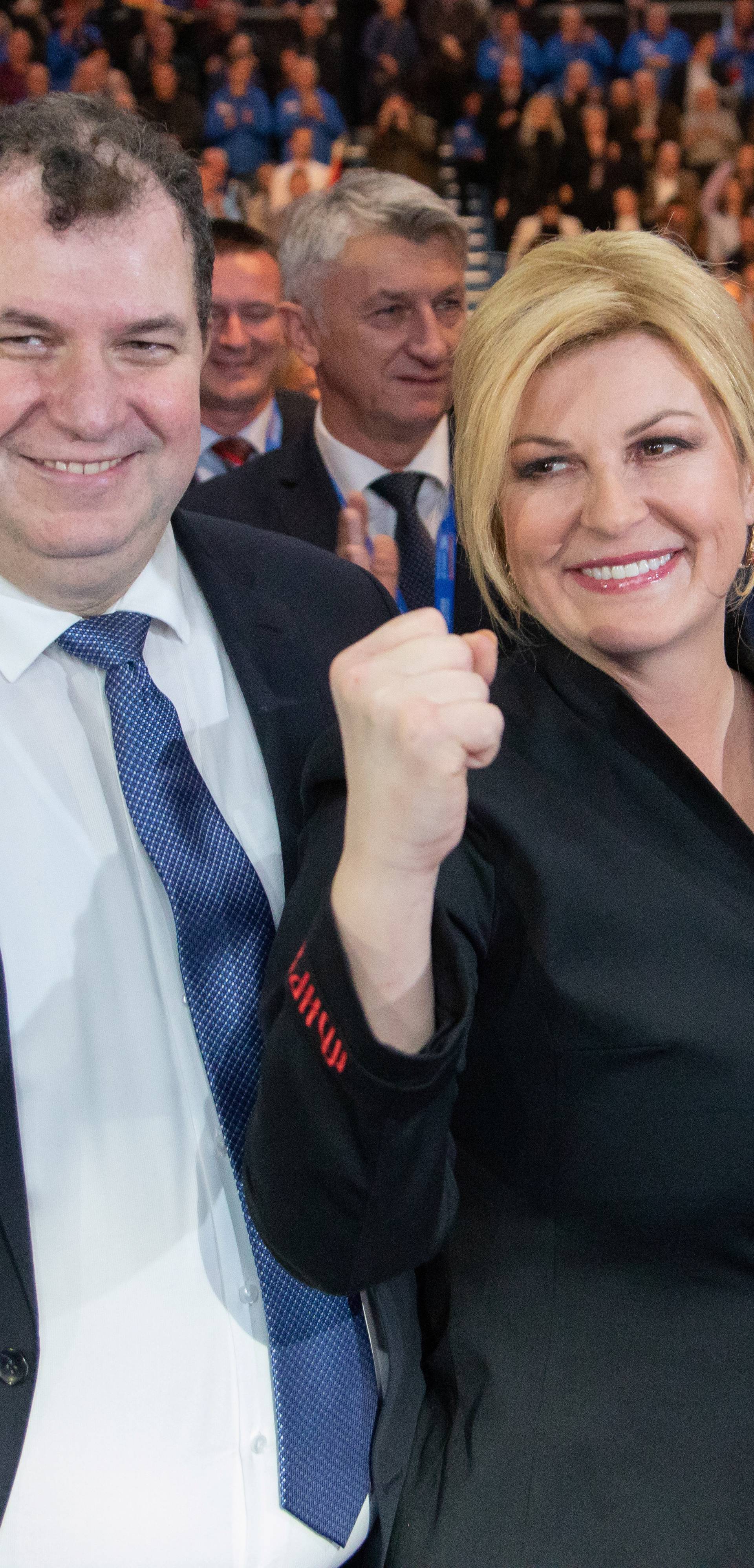 Croatia's President Kolinda Grabar Kitarovic and presidential candidate poses for a picture with her husband Jakov Kitarovic during an election rally at Cibona hall in Zagreb