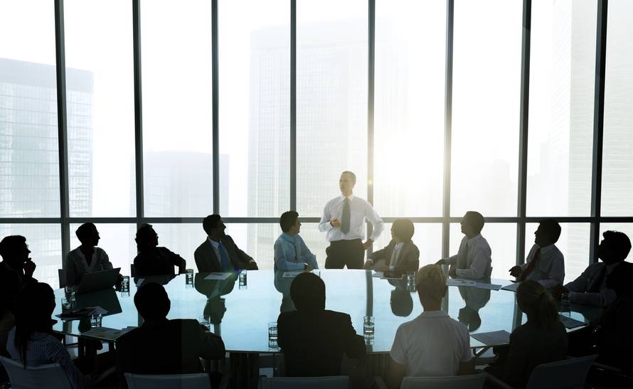 Leader,Talking,To,Business,Team,At,Meeting,Table