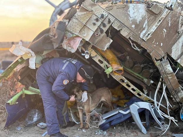 Emergency specialists work at the crash site of a passenger plane near Aktau