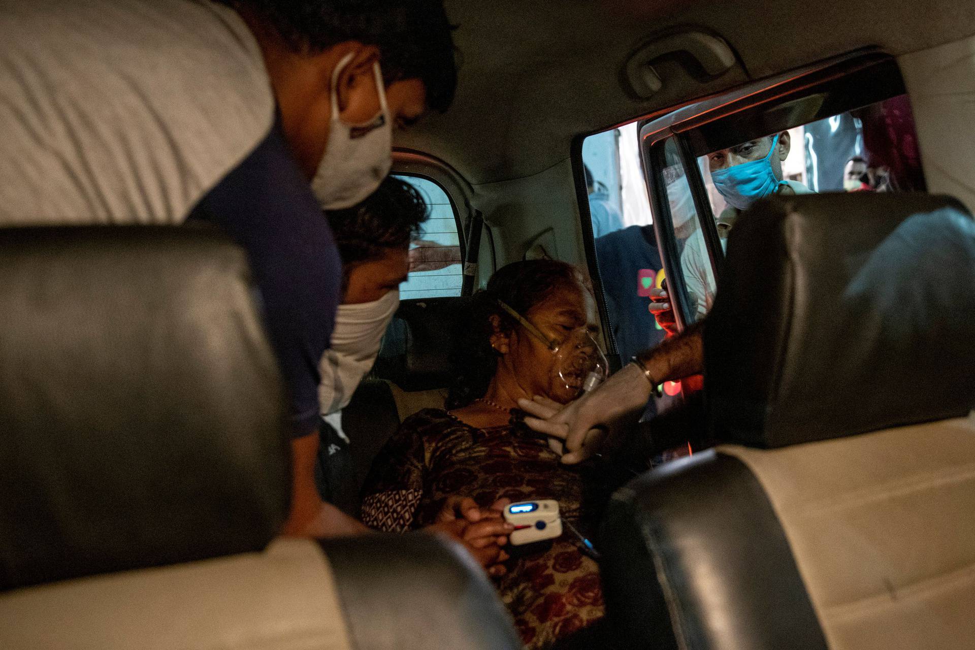 A volunteer performs CPR on a woman with breathing problems, in Ghaziabad