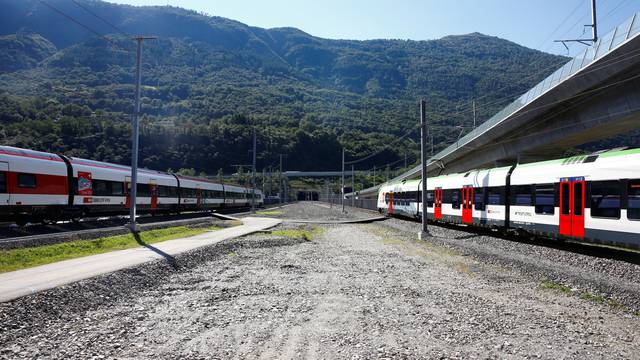 Trains stand in front the entrances of the newly built Ceneri Base Tunnel near Camorino