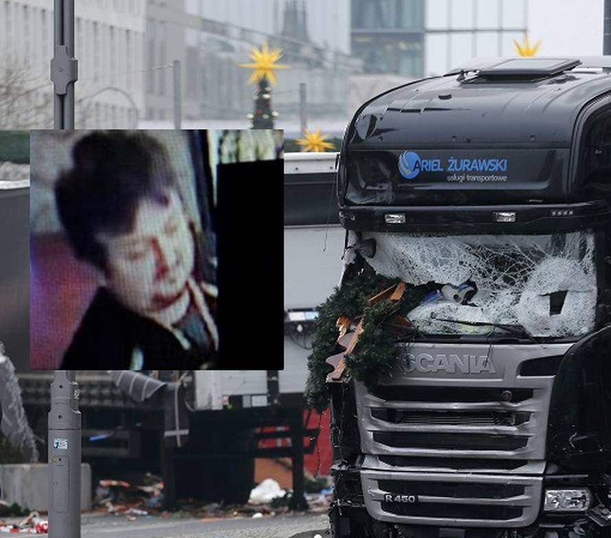 Police stand in front of the truck which ploughed last night into a crowded Christmas market in the German capital Berlin