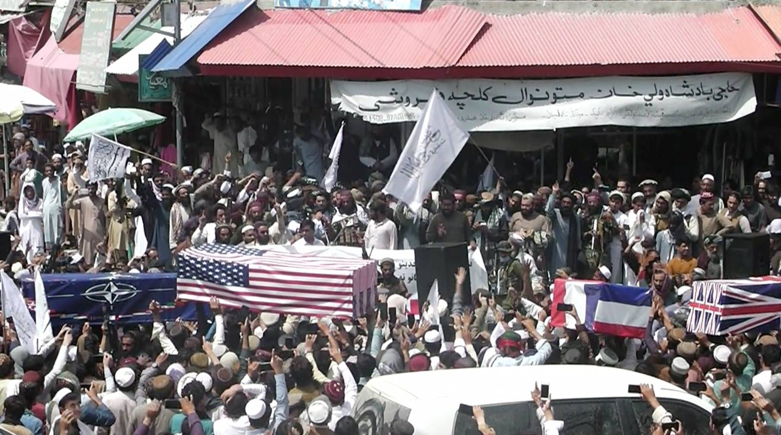 U.S. and NATO flags flank coffins at mock funeral held by Taliban