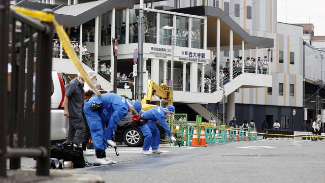 Investigators work around the scene where former Japanese Prime Minister Shinzo Abe was shot from behind by a man in Nara