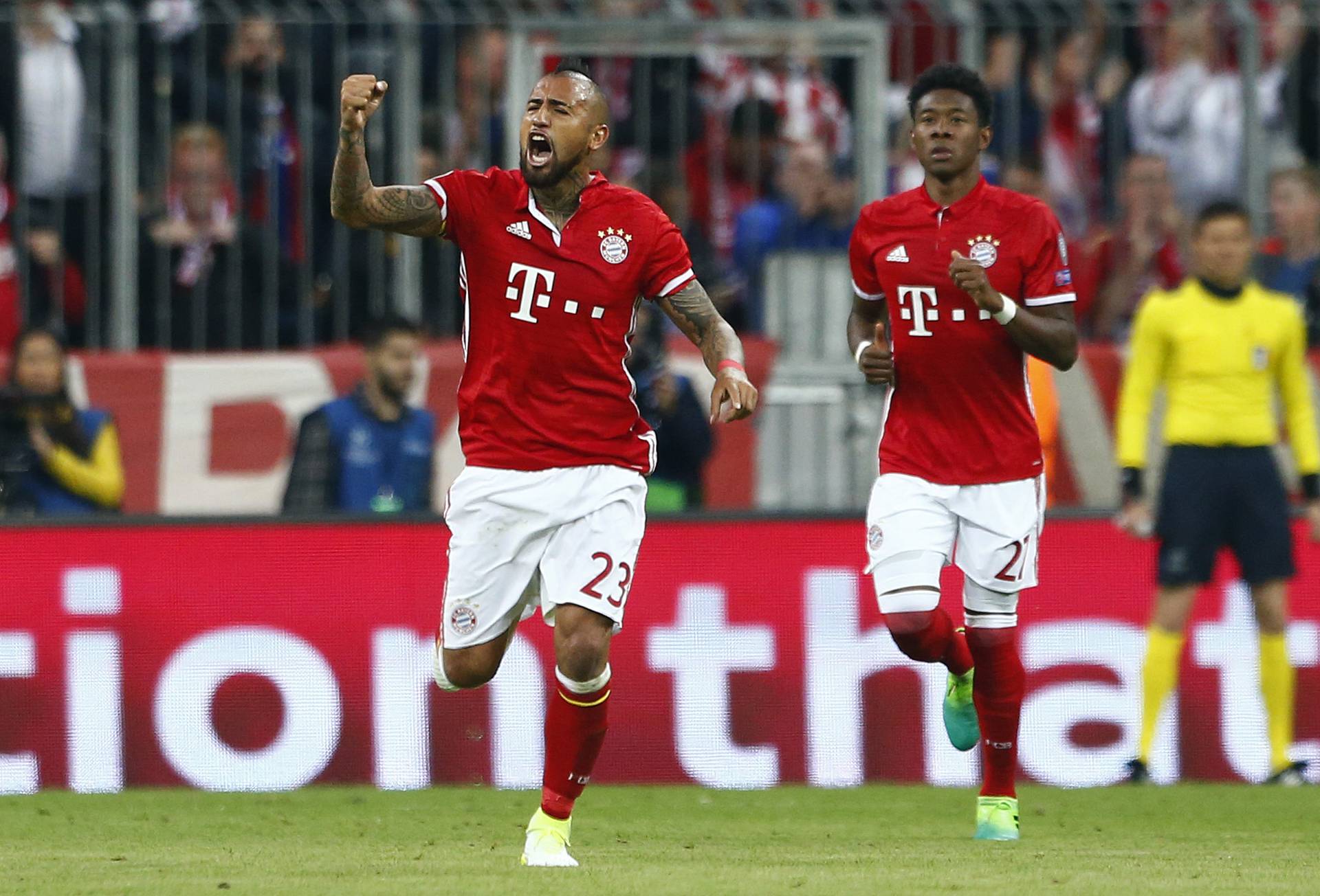Bayern Munich's Arturo Vidal celebrates scoring their first goal with David Alaba
