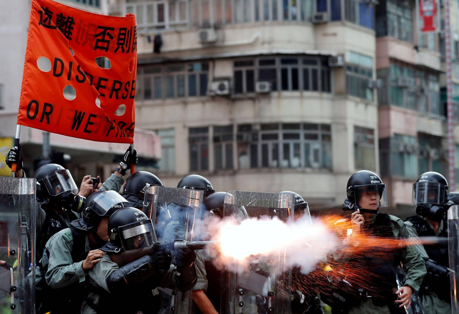 Police officers fire tear gas as anti-extradition bill protesters demonstrate in Sham Shui Po neighbourhood in Hong Kong,