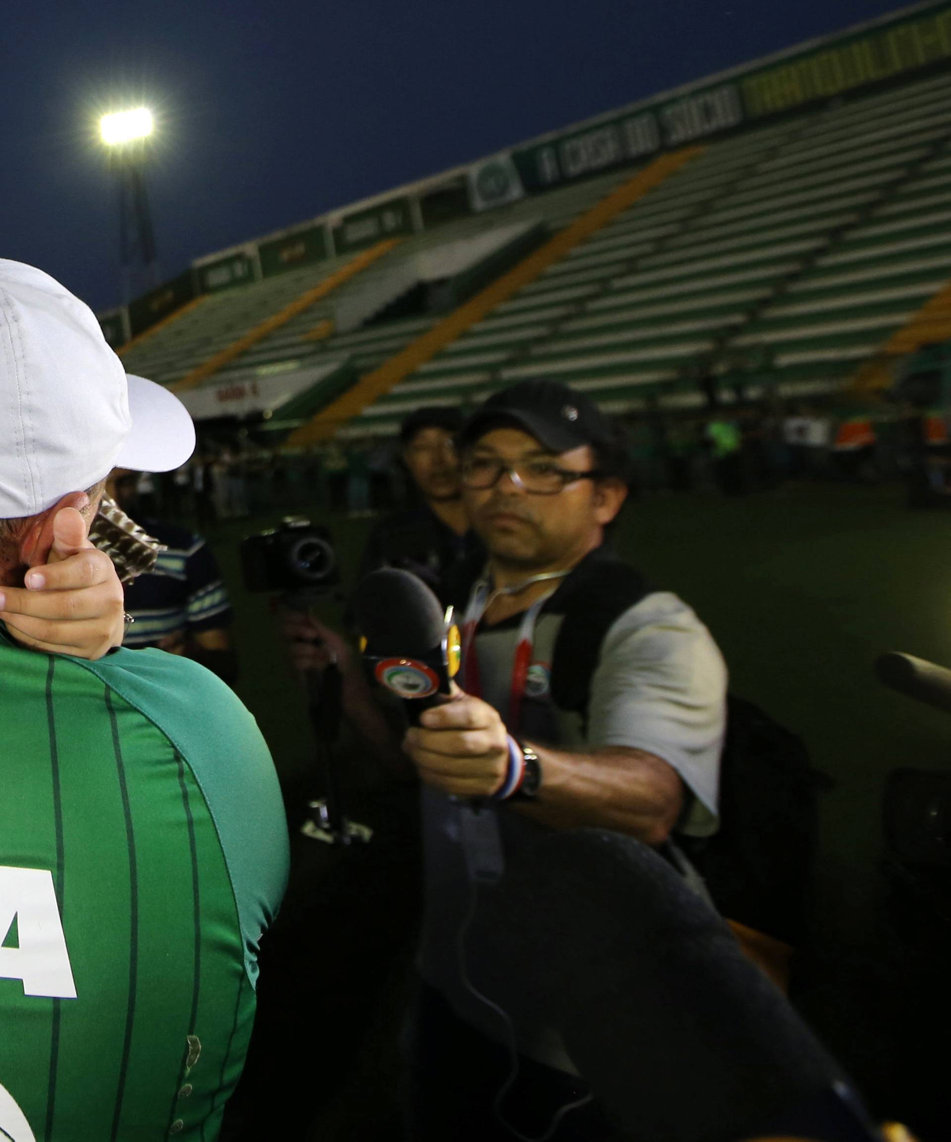 A fan of Chapecoense soccer team and his son react at the Arena Conda stadium in Chapeco