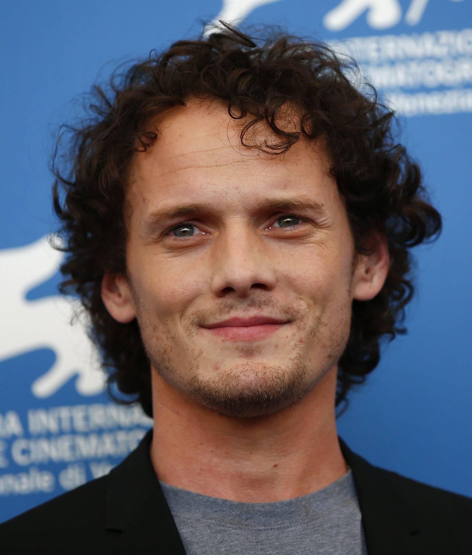Cast member Yelchin poses during the photo call for the movie "Burying the ex" at the 71st Venice Film Festival