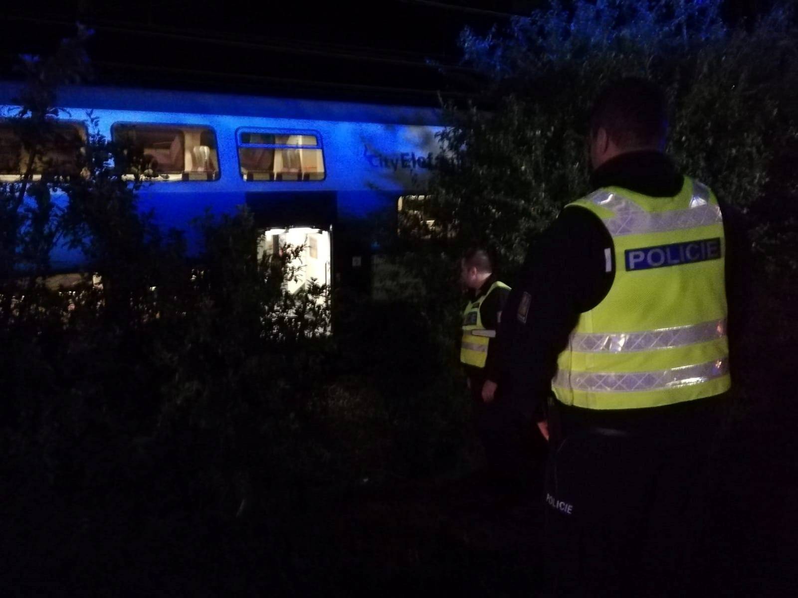 Police officers are seen at the site of a train accident in Cesky Brod