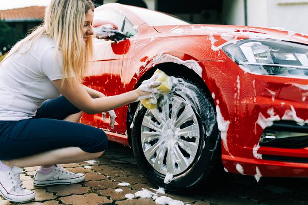 Young,Woman,Washing,Her,Car,With,Sponge.