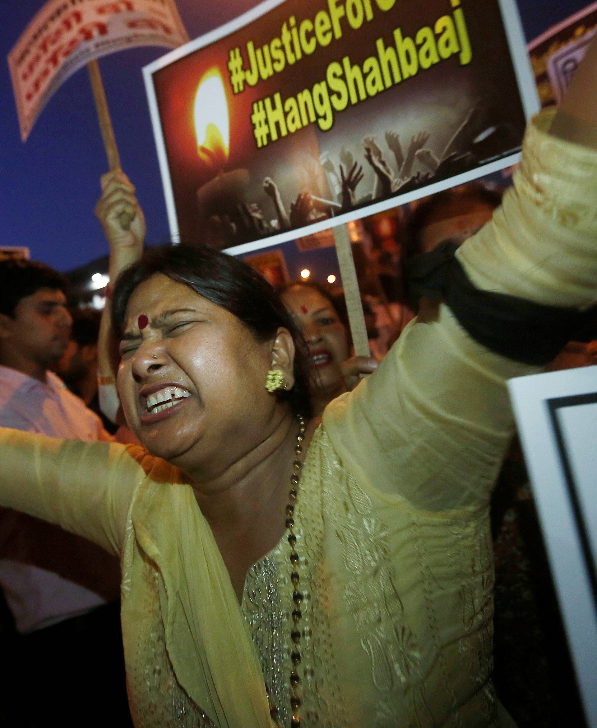 A woman shouts slogans during a protest against the rape of a ten-year-old girl, in the outskirts of Delhi