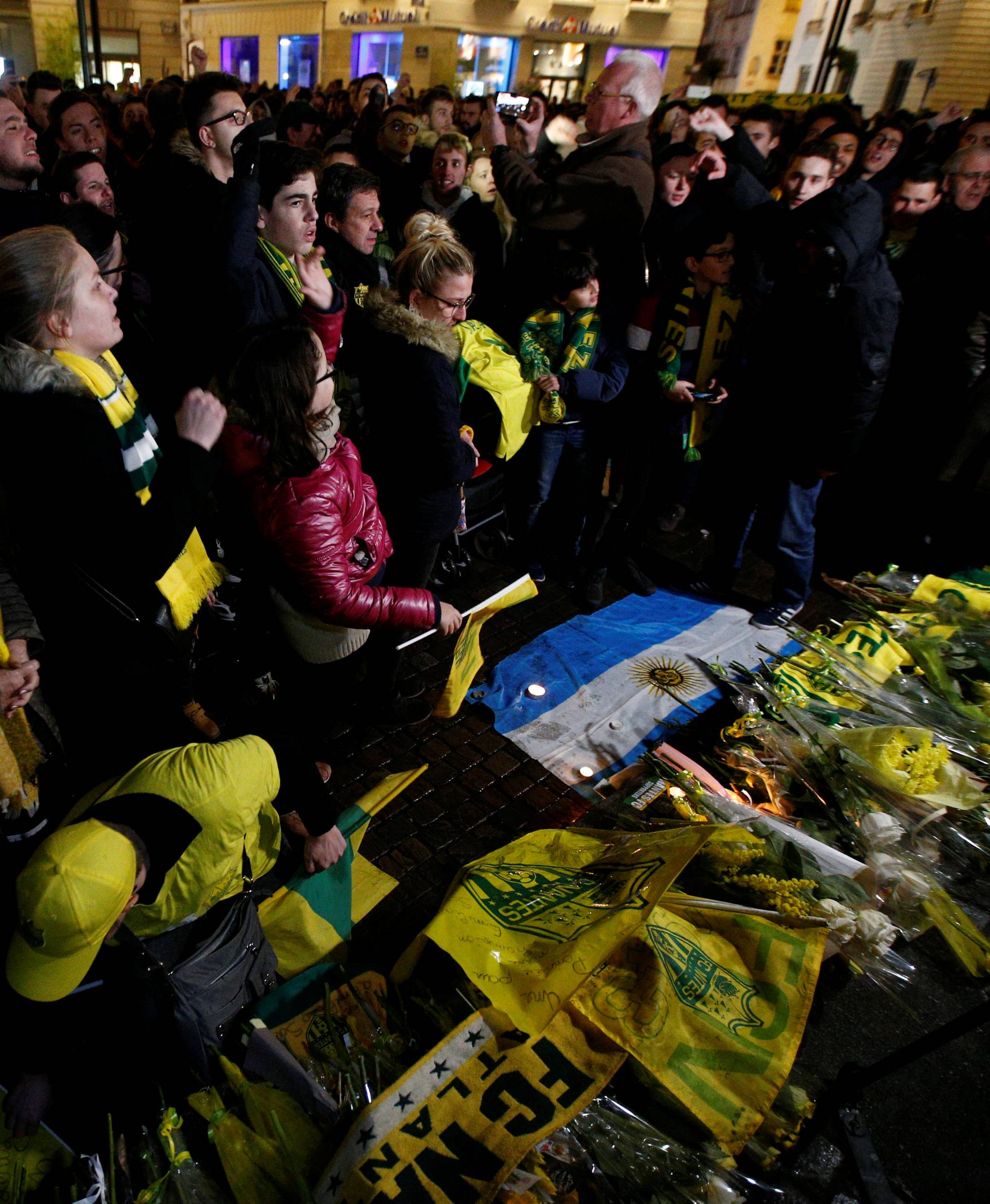 Fans gather near a row of yellow tulips in Nantes' city center after news that newly-signed Cardiff City soccer player Emiliano Sala was missing after the light aircraft he was travelling in disappeared between France and England