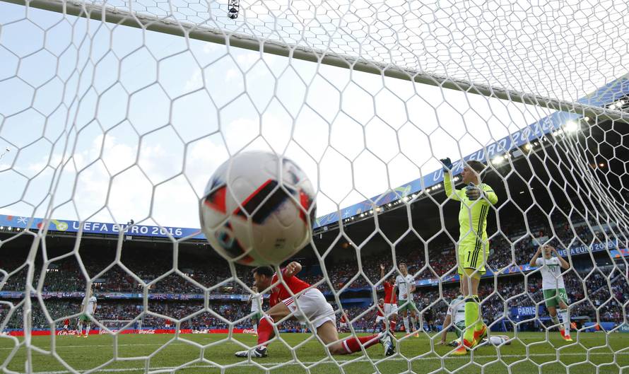 Northern Ireland's Gareth McAuley scores an own goal