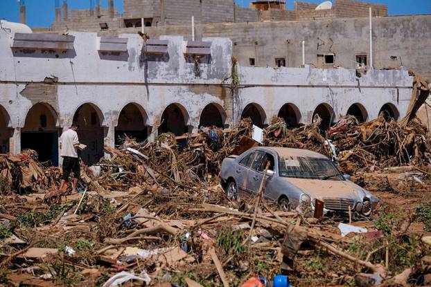 A view shows a damaged car, following a powerful storm and heavy rainfall hitting the country, in Derna