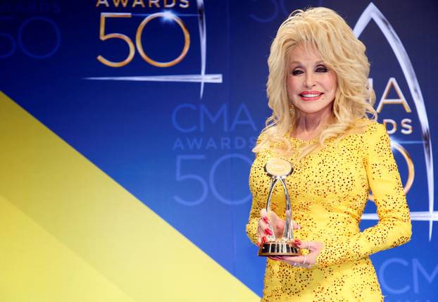 FILE PHOTO: Dolly Parton poses with her award during the 50th Annual Country Music Association Awards in Nashville
