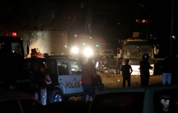 Police inspect a scene of a bus blast in Giza