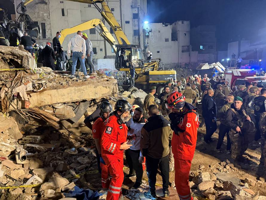 Rescue teams search for survivors after a building collapsed in Tripoli