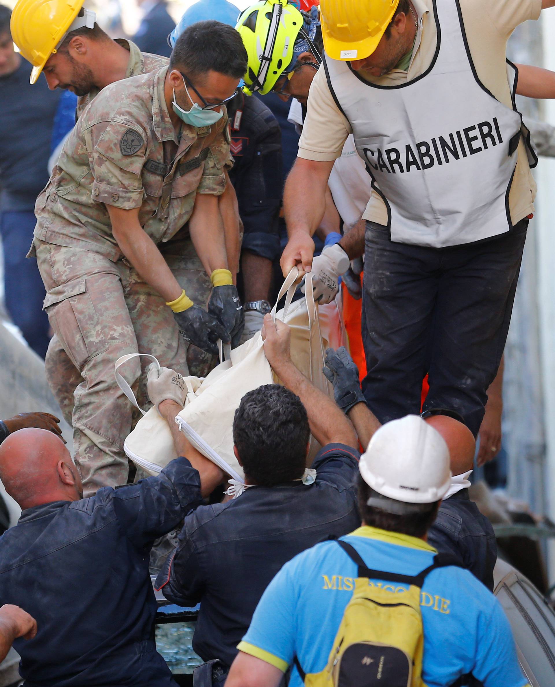 A body is carried away following an earthquake in Amatrice