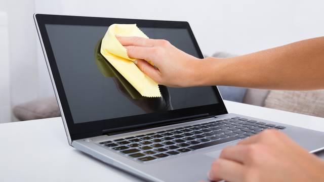 Woman Hand Cleaning Laptop Screen