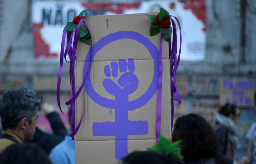 FILE PHOTO: Women attend a meeting to mark International Women's Day in downtown Lisbon