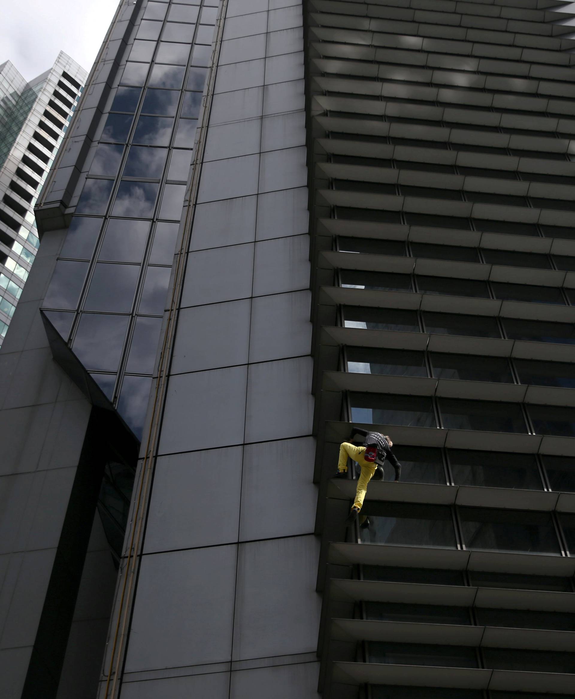 French climber Robert scales the 47-storey GT International Tower in Makati City