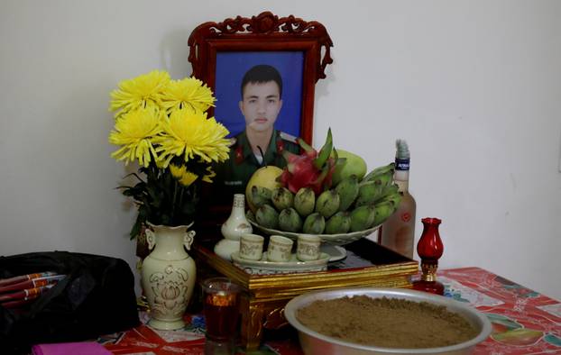 An image of Nguyen Dinh Tu, a Vietnamese suspected to be among dead victims found in a lorry in Britain, is seen at a table at his home in Nghe An province