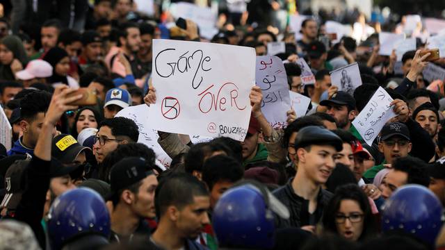 Students take part in a protest to denounce an offer by President Abdelaziz Bouteflika to run in elections next month but not to serve a full term if re-elected, in Algiers