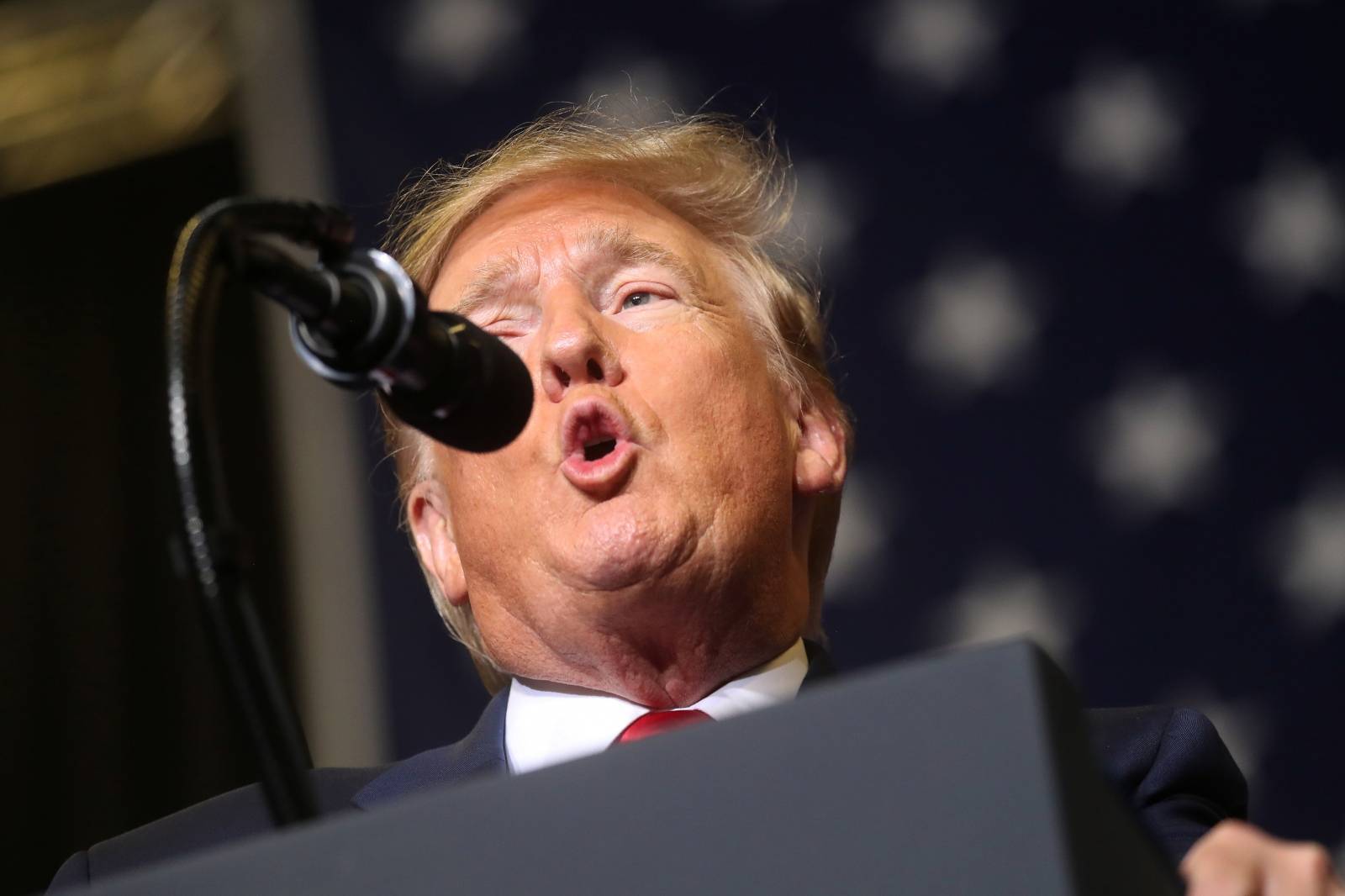 U.S. President Donald Trump reacts during a campaign rally in Tupelo