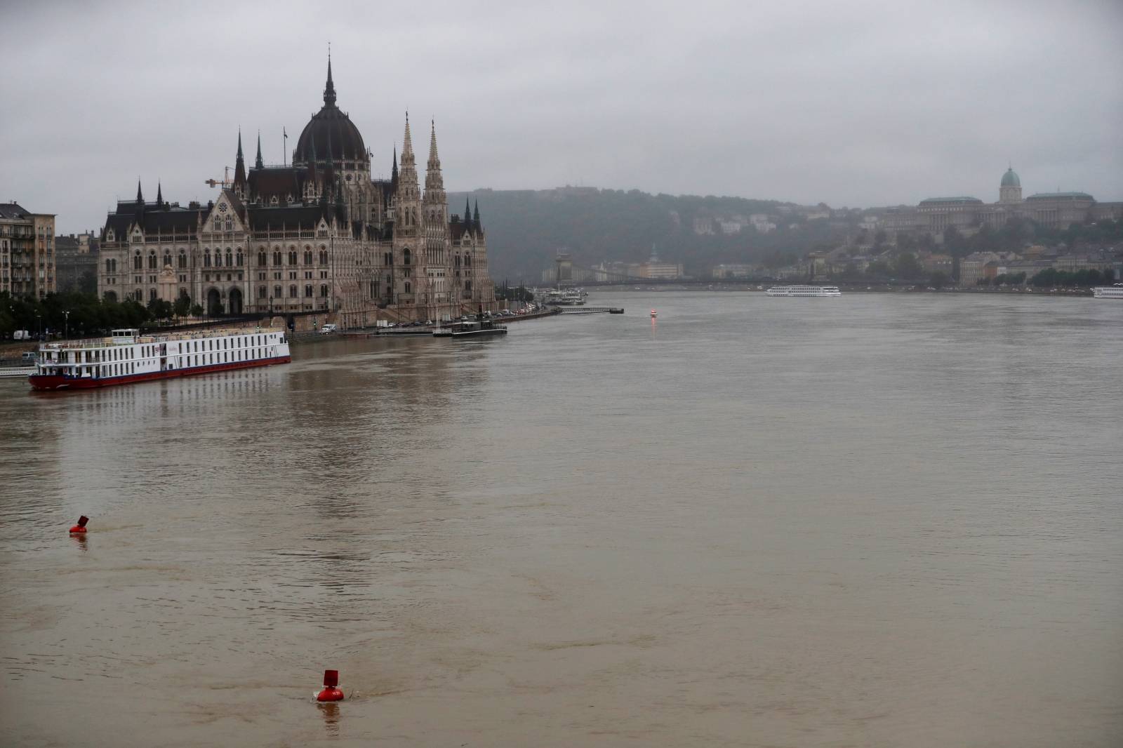 A river cruise boat is seen in front of the Hungarian Parliament on the Danube river in Budapest