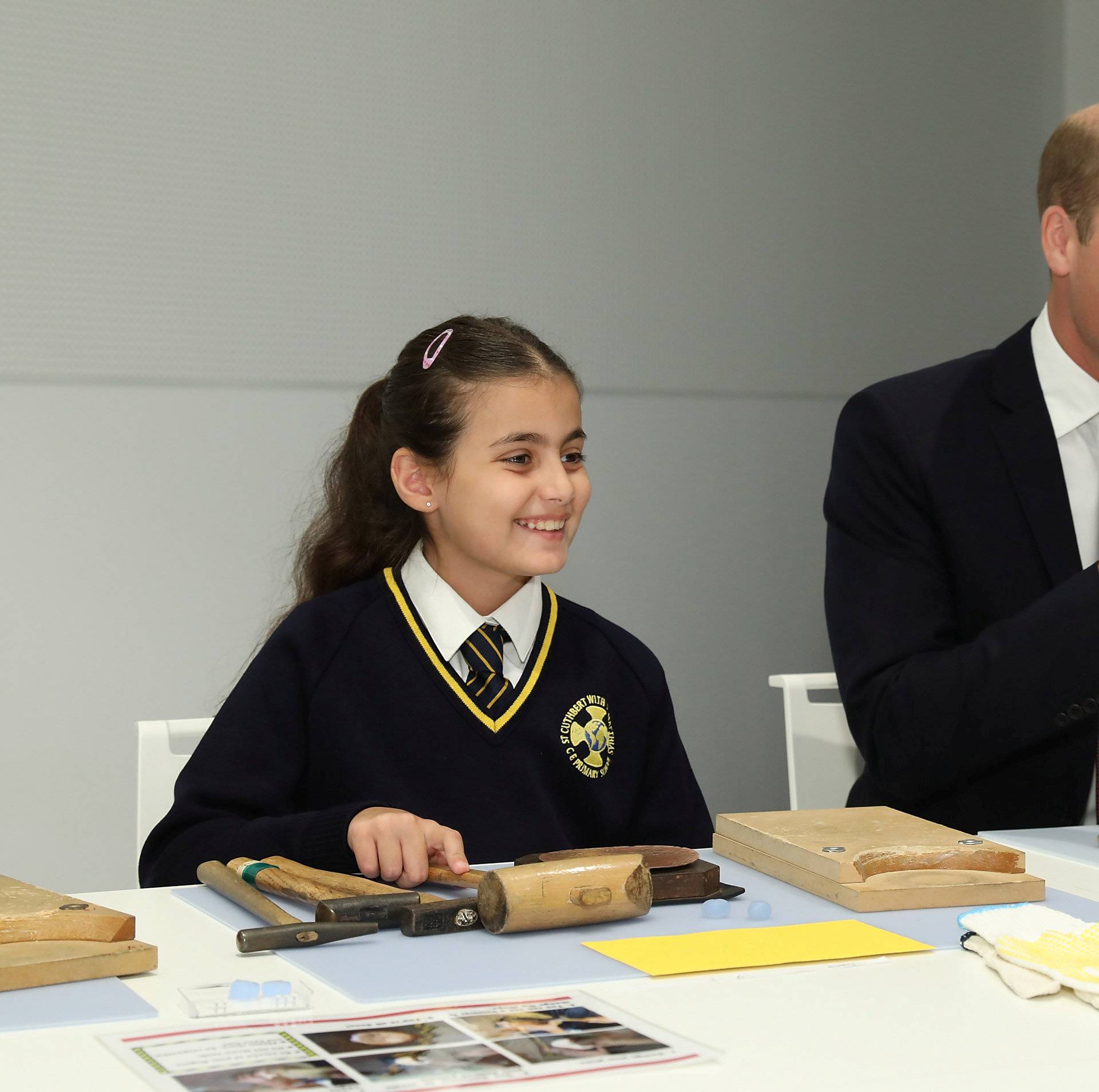 Britain's Prince William joins local school children from St Cuthbert with St Matthias CE Primary School at a copper beating workshop during the official opening of Japan House in London