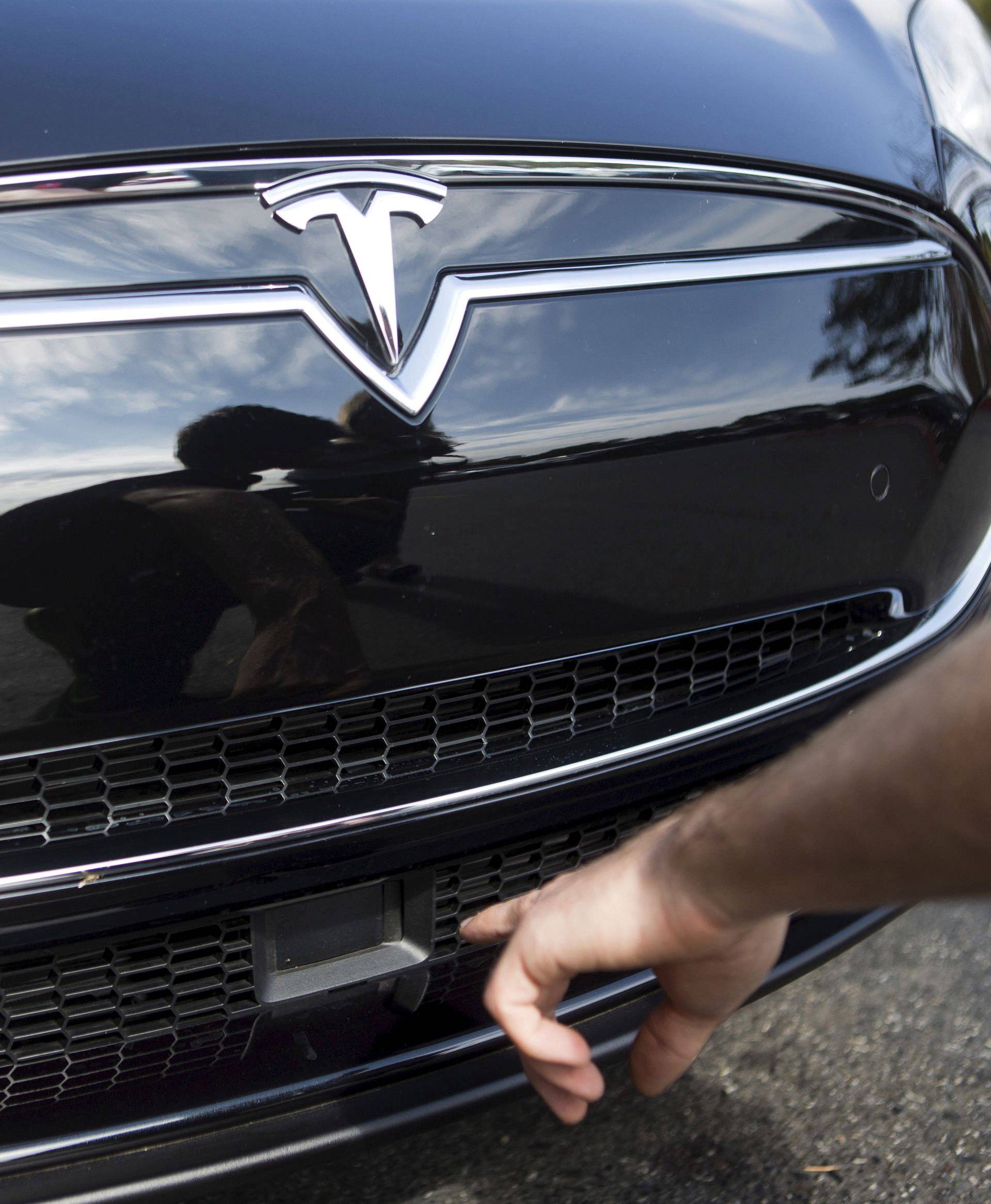 The radar technology of a Tesla Model S being pointed out during a Tesla event in Palo Alto