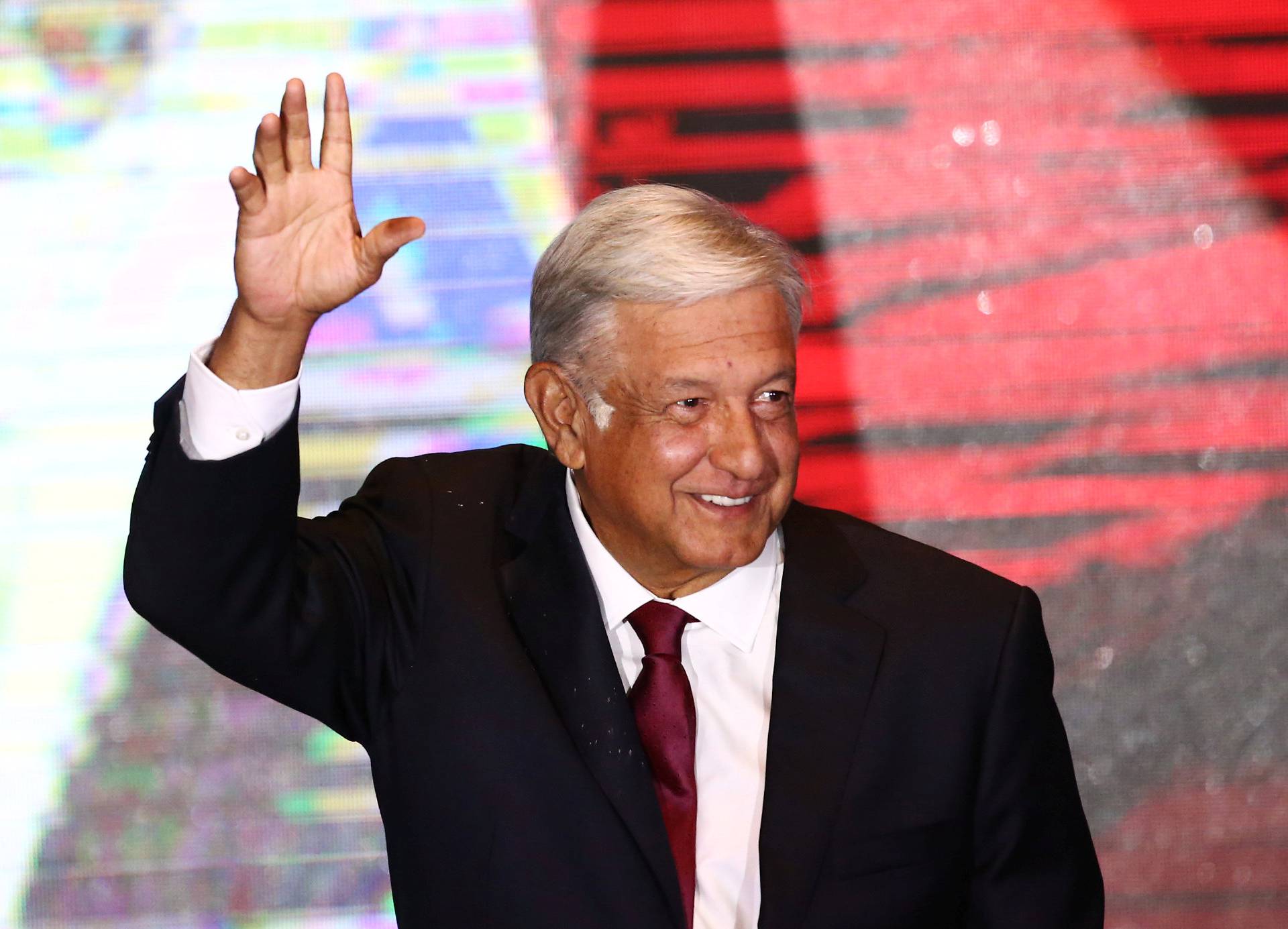 Presidential candidate Andres Manuel Lopez Obrador waves as he addresses supporters after polls closed in the presidential election, in Mexico City