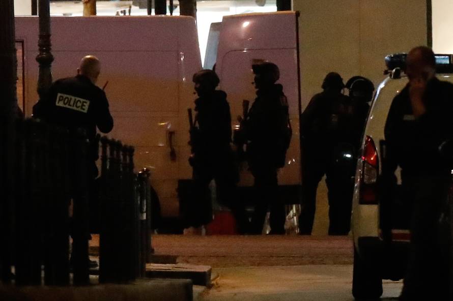 Police secure a side street as others conduct an investigation on the Champs Elysees Avenue after one policeman was killed and another wounded in a shooting incident in Paris