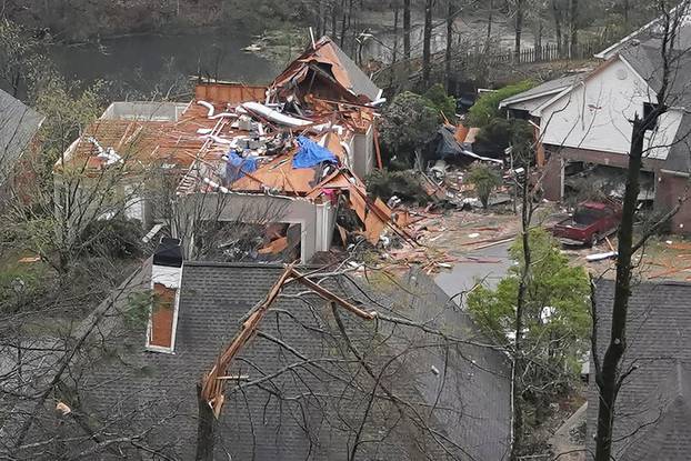 A house is left missing a roof after a tornado passed through the Eagle Point subdivision in Hoover