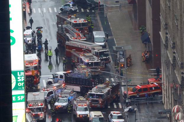 Emergency vehicles are seen outside 787 7th Avenue in midtown Manhattan where a helicopter crashed in New York