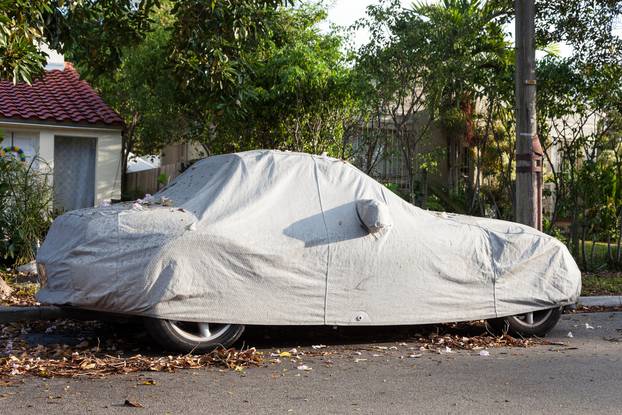 Car underneath a car cover